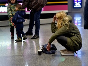 A woman reacts at the arrival gate of the Boryspil airport outside Kiev on Jan. 8, 2020, after a Ukrainian airliner carrying 176 people from seven countries crashed shortly after takeoff from Tehran.