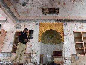 A policeman inspects a mosque following a bomb blast in a mosque a day before, in Quetta on January 11, 2020.