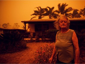 Nancy Allen and Brian Allen stand outside the house as high winds push smoke and ash from the Currowan Fire towards Nowra, New South Wales, Australia January 4, 2020.