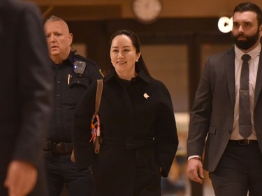 Huawei chief financial officer Meng Wanzhou leaves British Columbia Supreme Court with her security detail after the second day of her extradition hearing on January 21, 2020 in Vancouver, British Colombia. - The Chinese telecommunications executive whose arrest in Vancouver badly strained Canada-China relations went to court on Monday to fight extradition to the United States, with her lawyers calling the accusations against her "fiction." Meng Wanzhou, the chief financial officer of tech giant Huawei and eldest daughter of its founder Ren Zhengfei, is wanted by US authorities for alleged fraud. (Photo by Don MacKinnon / AFP)