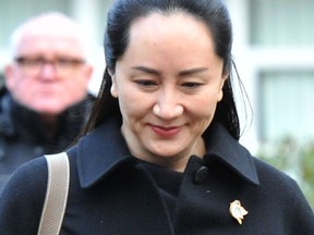 Huawei chief financial officer Meng Wanzhou leaves her Vancouver home with her security detail for an extradition hearing in British Columbia Supreme Court, on January 21, 2020 in Vancouver, British Colombia. - The Chinese telecommunications executive whose arrest in Vancouver badly strained Canada-China relations went to court on Monday to fight extradition to the United States, with her lawyers calling the accusations against her "fiction." Meng Wanzhou, the chief financial officer of tech giant Huawei and eldest daughter of its founder Ren Zhengfei, is wanted by US authorities for alleged fraud. (Photo by Don MacKinnon / AFP)