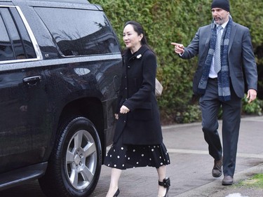 Huawei chief financial officer Meng Wanzhou leaves her Vancouver home to begin her extradition hearing in British Columbia Supreme Court, on January 20, 2020 in Vancouver, British Colombia. - The chief financial officer of China's Huawei arrived Monday morning at a Canadian court for the start of a hearing for her extradition to the United States. Meng Wanzhou wore a black dress that exposed an electronic ankle bracelet that authorities ordered her to wear as a condition of her release from custody. She made no comment on entering the court. (Photo by Don MacKinnon / AFP)