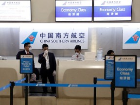 China Southern Airlines employees wear a surgical mask as a preventive measure in light of the coronavirus outbreak in China, as they wait for customers behind the counter at Benito Juarez international airport in Mexico City, Mexico January 28, 2020.