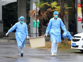 Medical staff carry a box as they walk at the Jinyintan hospital, where patients with pneumonia caused by a new strain of coronavirus are being treated, in Wuhan, Hubei province, China, on Jan. 10, 2020.