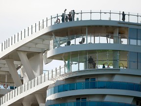 Passengers stand on Costa Smeralda cruise ship docked in the Civitavecchia port 70 km north of Rome on Jan. 30, 2020.