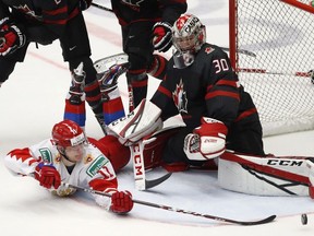 Russia's Vasili Podkolzin, left, fails to score past Canada's goaltender Joel Hofer, right, during the U20 Ice Hockey Worlds gold medal match between Canada and Russia in Ostrava, Czech Republic, Sunday, Jan. 5, 2020.