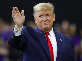 U.S. President Donald Trump waves prior to the College Football Playoff National Championship game between the Clemson Tigers and the LSU Tigers at Mercedes Benz Superdome in New Orleans, Monday, Jan. 13, 2020.