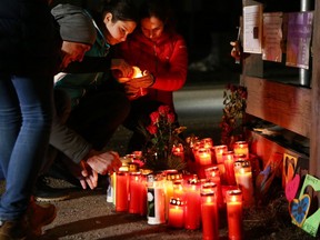 People lay candles and flowers on Via Aurina SS 621, in Lutago, South Tyrol, on January 5, 2020, at the location where a drunk driver ploughed into pedestrians killing six German tourists and injuring 11 other people.