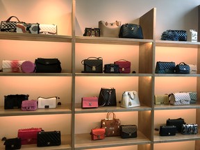 Purses line the wall of the 1,500-square-foot handbag vault at luxury resaler The RealReal.