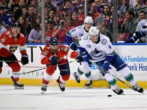 J.T. Miller of the Vancouver Canucks charges up ice with the puck on Thursday as the Florida Panthers' Vincent Trocheck gives chase. The Panthers defeated the Canucks 5-2 at the BB&T Center in Sunrise, Fla.