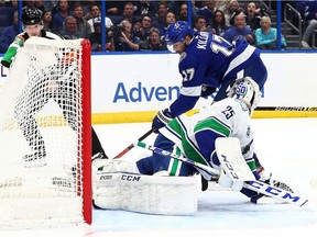 Tampa Bay Lightning forward Alex Killorn (17) shoots on goal as Vancouver Canucks goaltender Jacob Markstrom (25) makes a save during the first period at Amalie Arena.