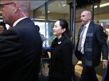 VANCOUVER, BC - JANUARY 20: Huawei Technologies Chief Financial Officer Meng Wanzhou is escorted by her security personnel as she leaves court during a break for lunch on the first day of her extradition trial on January 20, 2020 in Vancouver, Canada. The United States government accused Wanzhou of fraud after HSBC continued trade with Iran while sanctions were in place.