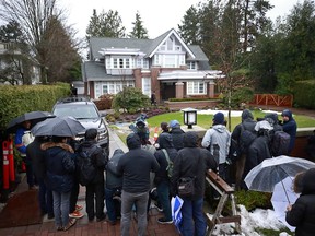 Members of the media stand outside the Vancouver home of Huawei Technologies Chief Financial Officer Meng Wanzhou as they wait for her to leave for a court appearance on the first day of her extradition trial on January 20, 2020 in Vancouver, Canada.