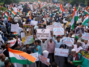 Demonstrators hold placards and flags as they attend a protest rally against a new citizenship law, in Hyderabad, India, January 4, 2020.