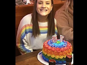 Kayla Kenney posing in front of her birthday cake.