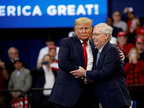 Senator Mitch McConnell (R-KY) hugs U.S. President Donald Trump at a Keep America Great Rally at the Rupp Arena in Lexington, Kentucky, U.S., November 4, 2019.