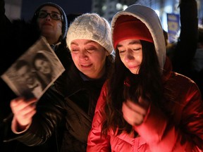 Mourners attend an outdoor vigil in Toronto on Jan. 9, 2020, for the victims of Ukraine International Airlines Flight 752, which crashed in Iran on Jan. 8. Fifty-seven Canadians died in the crash.