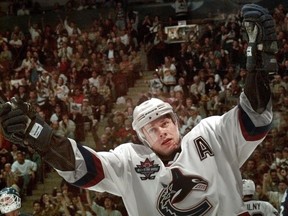 Pavel Bure cheers after scoring his 51st goal of the NHL season in what would be his final game as a Vancouver Canuck. He also picked up a small cut on the chin as a memento from the game against the Toronto Maple Leafs.