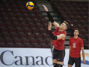 National men's captain Gord Perrin, left, and Ryan Sclater practise at the Pacific Coliseum in Vancouver on Thursday ahead of a four-team Olympic qualifying tournament that tips off Friday.