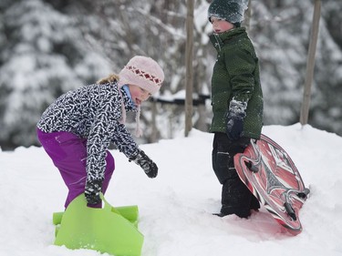 Schools are closed across the region and many people found it impossible to make it to work as transit was affected and roads nearly impassable. Emily Payne,9, (left) and brother Erik Payne, 6, take advantage of the conditions at Pioneer Park on Burke Mountain in Coquitlam, BC.