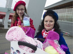 Kris Sims, executive director of the Canadian Taxpayers Federation, and daughter Gretel, 11, with a basket of items that will be donated to Vancouver's Downtown Eastside Women's Centre on behalf of Prince Harry and Meghan Markle.