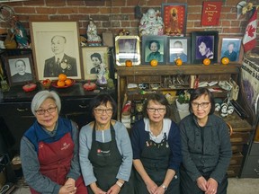 Left to right: Deanna Wong, Diane Chan, Theresa Williams and Fontaine Wong with family portraits inside the Ming Wo building in Chinatown.