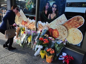 A mourner at a memorial outside a North Vancouver bakery for victims of the Ukraine Airlnes plane crash in Tehran.