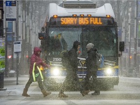 File photo of people walking in the snow in Vancouver.