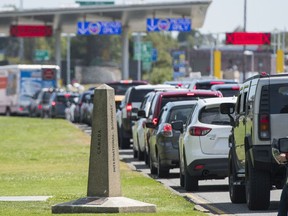 Cars line up waiting to cross into the United States at the Peace Arch Border Crossing in Surrey, BC, July, 24, 2017.