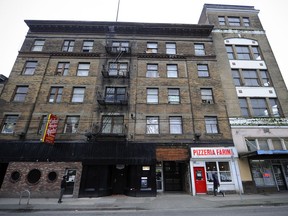 People walk in front of hotels near Main and Terminal streets as plans are being developed for a new St. Paul's Hospital on nearby Station Street. Gentrification of the area around the new hospital site puts 500 low-income hotel rooms at-risk, activists have said.