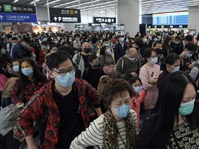 Passengers wear protective face masks at the departure hall of the high speed train station in Hong Kong.