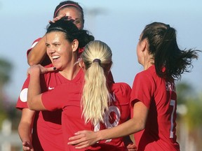 Canada's Christine Sinclair, front left, celebrates with teammates after scoring against St. Kitts and Nevis during a CONCACAF women's Olympic qualifying soccer match Wednesday, Jan. 29, 2020, in Edinburg, Texas.