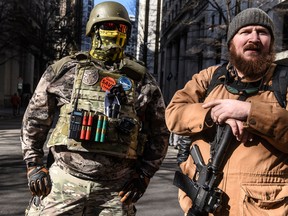 Two armed militia members gather near the Virginia State Capitol building in Richmond, Virginia, U.S., January 20, 2020.