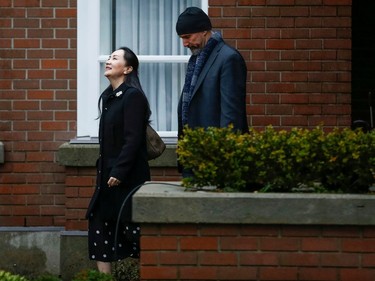 Huawei Chief Financial Officer Meng Wanzhou walks with a member of her security as she leaves her home to attend the start of her extradition hearing at B.C. Supreme Court in Vancouver, British Columbia, Canada January 20, 2020.  REUTERS/Lindsey Wasson