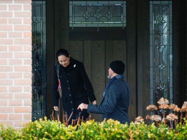 Huawei Chief Financial Officer Meng Wanzhou is greeted by a member of her security as she leaves her home to attend the start of her extradition hearing at B.C. Supreme Court in Vancouver, British Columbia, Canada January 20, 2020.  REUTERS/Lindsey Wasson
