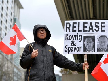 Steven Song and a small group of protesters hold signs and flags outside of B.C. Supreme Court during Huawei Chief Financial Officer Meng Wanzhou's extradition hearing in Vancouver, British Columbia, Canada January 21, 2020.  REUTERS/Jennifer Gauthier
