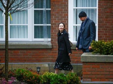 Huawei Chief Financial Officer Meng Wanzhou walks with a member of her security as she leaves her home to attend the start of her extradition hearing at B.C. Supreme Court in Vancouver, British Columbia, Canada January 20, 2020.  REUTERS/Lindsey Wasson
