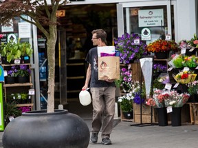 A customer uses a paper bag at Fairway Market on Quadra Street in Victoria.