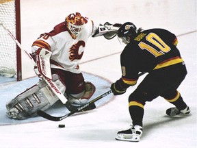 Vancouver Canucks Pavel Bure scoring the winning goal against Mike Vernon in the second overtime period against the Calgary Flames, April 30, 1994.