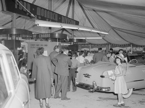 A 1949 Ford Custom convertible seems a crowd pleaser during the 1949 Pacific International Auto Show at the PNE.