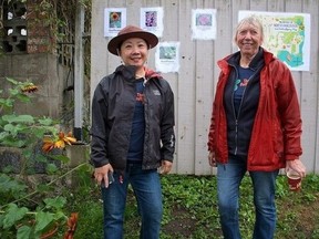 Winnie Hwo (left) and butterflyway ranger Carolyn Coles last summer at Butterflyway Lane in the District of North Vancouver between Bournmouth Crescent and Dollarton Highway. (Submitted photo)