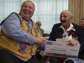 Ernest "Ted" Letendre accepted a $20,000 cheque from minister of veterans for the Metis National Council David Chartrand at the George Derby Centre in Burnaby.