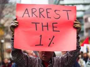 A protester displays a sign during an Occupy Toronto in October 2011, joining the Occupy Wall Street demonstrations that began in New York.