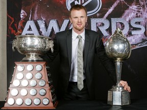 Henrik Sedin, in 2009-10, has the single biggest haul of NHL hardware the Canucks franchise had ever seen, as he picked up the Art Ross Trophy (left) as the league’s leading scorer at the Hart Memorial Trophy (right) as its most valuable player.