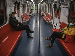 People wear protective masks as they ride on a nearly empty subway car during the evening rush period on February 10, 2020 in Beijing, China. The number of cases of a deadly new coronavirus rose to more than 40000 in mainland China Monday, days after the World Health Organization (WHO) declared the outbreak a global public health emergency. China continued to lock down the city of Wuhan in an effort to contain the spread of the pneumonia-like disease which medicals experts have confirmed can be passed from human to human. In an unprecedented move, Chinese authorities have put travel restrictions on the city which is the epicentre of the virus and municipalities in other parts of the country affecting tens of millions of people. The number of those who have died from the virus in China climbed to over 900 on Monday, mostly in Hubei province, and cases have been reported in other countries including the United States, Canada, Australia, Japan, South Korea, India, the United Kingdom, Germany, France and several others. The World Health Organization has warned all governments to be on alert and screening has been stepped up at airports around the world. Some countries, including the United States, have put restrictions on Chinese travellers entering and advised their citizens against travel to China. (Photo by Kevin Frayer/Getty Images)