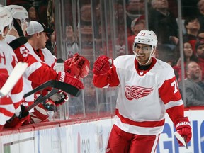 Andreas Athanasiou gets congratulated by his Detroit Red Wings teammates after scoring a goal during a Feb. 13, 2020 NHL game in Newark, N.J.