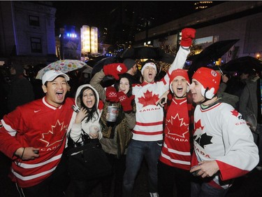 Vancouverites celebrated as they walked along Robson St. after the opening ceremonies of the 2010 Vancouver Olympic Games.    (Stuart Davis/PNG)  (For story)  -- PNG0212N CELEBRATION 01    TRAX NUMBER   00042501A.  [PNG Merlin Archive]