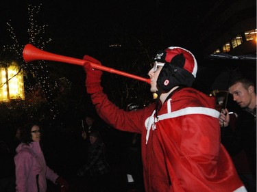 Vancouverites celebrated as they walked along Robson St. after the opening ceremonies of the 2010 Vancouver Olympic Games.    (Stuart Davis/PNG)  (For story)  -- PNG0212N CELEBRATION 02    TRAX NUMBER   00042501A.  [PNG Merlin Archive]