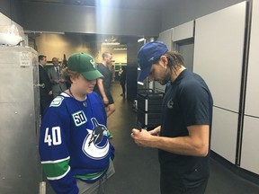Zach Tremblay of Castlegar, who is waiting for a kidney donor who is a match, hangs out with Chris Tanev of the Vancouver Canucks after a hockey game at Rogers Arena on Jan. 27. (Jana Tremblay photo)