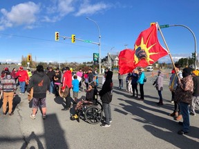 A group of protesters have blocked a major Victoria highway that accesses the airport and ferry terminal.